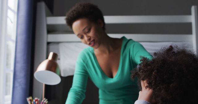 Mother Helping Child with Homework in Dimly Lit Room - Download Free Stock Images Pikwizard.com