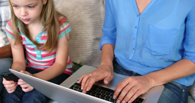 Mother and Daughter Engaging with Technology at Home - Download Free Stock Images Pikwizard.com