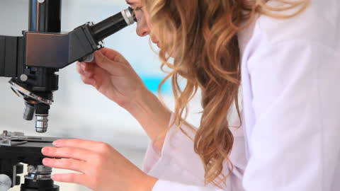Female Scientist Examining Samples in Modern Laboratory