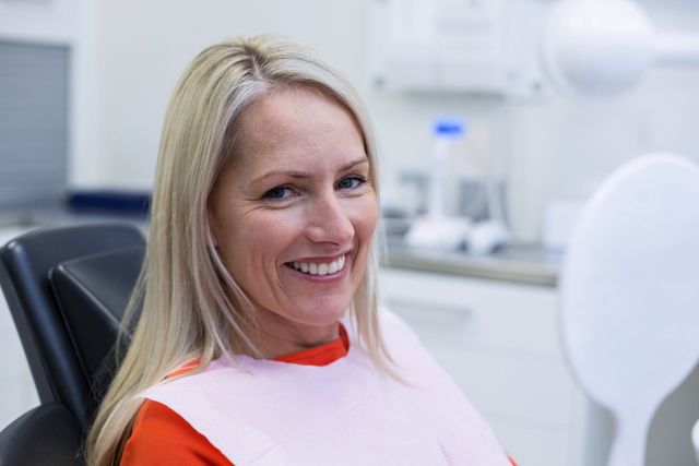 Smiling Woman at Dental Clinic - Download Free Stock Photos Pikwizard.com