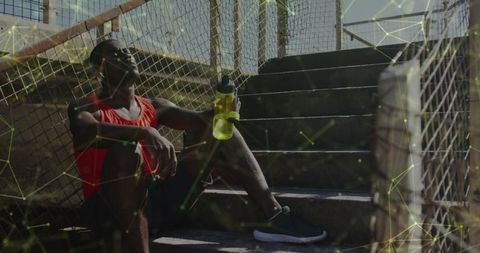 African American Athlete Resting With Digital Connections Overlay