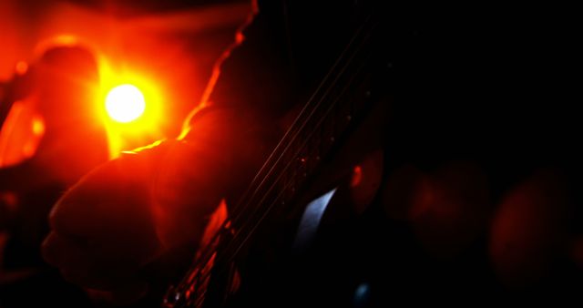 Musician Playing Electric Guitar on Stage with Red Backlighting - Download Free Stock Images Pikwizard.com