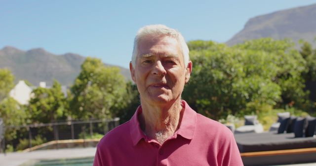 Senior Man Smiling Outside in Garden with Mountains in Background - Download Free Stock Images Pikwizard.com