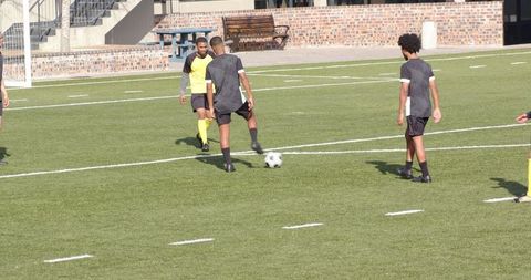 Soccer players preparing for team practice on field outdoors