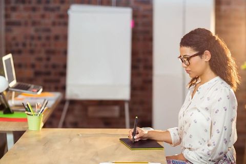Young Female Artist Sketching in Modern Studio Setting