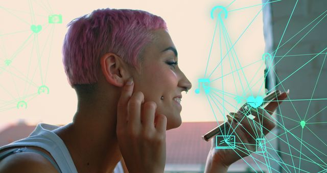 Young woman with pink hair is using a smartphone with futuristic digital interface graphics overlay. Ideal for ads or articles on communication, technology trends, social media engagement, and modern lifestyles. Perfect visual for topics on innovation and connectivity.