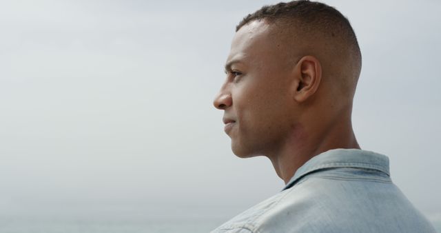 Thoughtful Young Man Looking Over Ocean Horizon - Download Free Stock Images Pikwizard.com