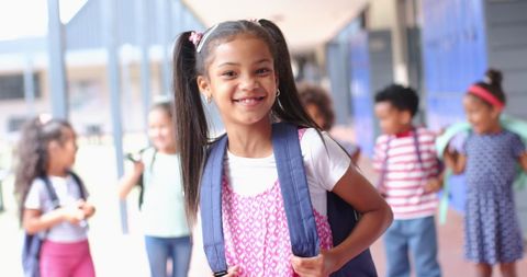 Happy Schoolgirl with Backpack Standing in Hallway - Download Free Stock Images Pikwizard.com