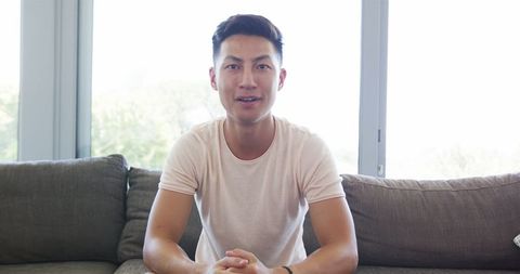 Young Man Relaxing and Communicating from Home