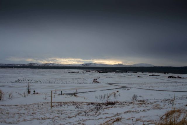 Snowy Landscape at Dusk with Mountains in Distance - Download Free Stock Photos Pikwizard.com