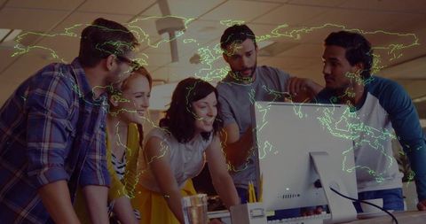 Team Collaborating Around Desktop with Neon World Map Overlay for Global Collaboration