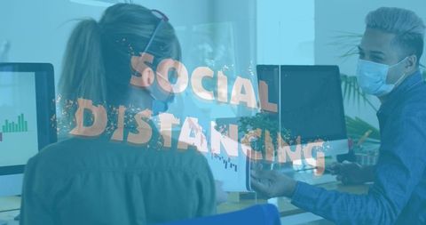 Office colleagues practicing social distancing with masks