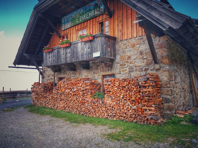 Rustic Alpine Cabin with Wood Stack and Flower-filled Balcony - Download Free Stock Photos Pikwizard.com