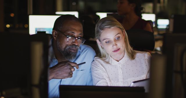 Colleagues Working Together on a Project in Dark Office - Download Free Stock Images Pikwizard.com