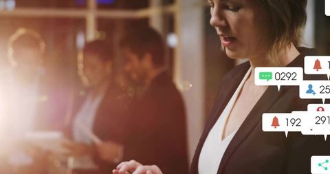Businesswoman engaging with real-time digital notifications in corporate scene