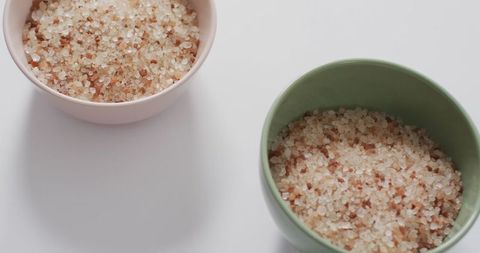 Himalayan Pink Salt in Ceramic Bowls on White Background
