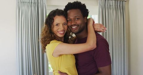 Smiling Biracial Couple Embracing in Brightroom - Download Free Stock Images Pikwizard.com