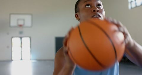Focused African American Woman with Basketball Aiming for Victory