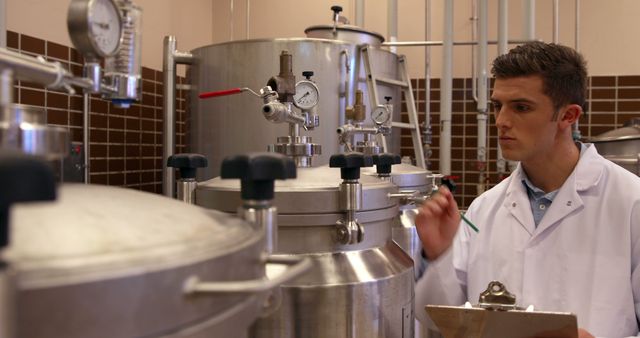 Young Scientist Analyzing Data in Laboratory with Industrial Equipment - Download Free Stock Images Pikwizard.com