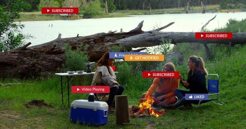 Friends Relaxing Together by Lake Camping and Enjoying Nature