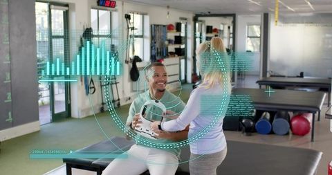 Therapist guiding seated medicine ball exercise with patient in modern rehab clinic
