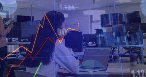 Working analyst typing at open office with charts and data visualization overlays