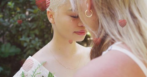 Female Couple Embracing with Falling Hearts