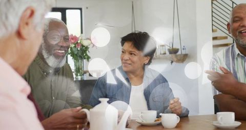 Diverse Group Socializing Over Coffee in Sunlit Dining Room