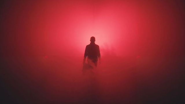 Solitary silhouette journey through red mist