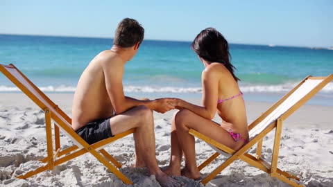Romantic Couple Enjoying Beachfront on Sunny Day