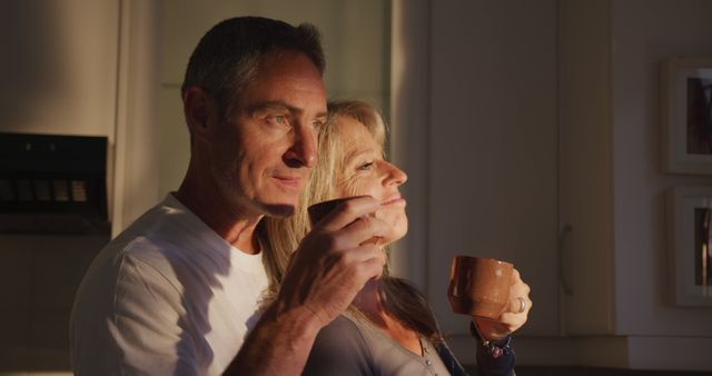 Middle-aged couple enjoying morning coffee together in kitchen - Download Free Stock Images Pikwizard.com