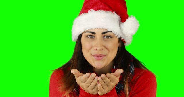 Young Woman Blowing Kiss Wearing Santa Hat for Christmas - Download Free Stock Images Pikwizard.com