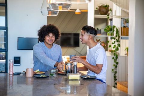 Friends enjoying morning chat with coffee and avocado toast