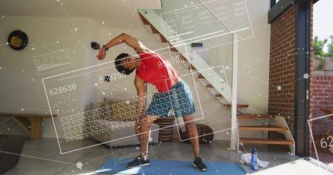 Young man stretching with augmented reality fitness ui in modern living room solo workout