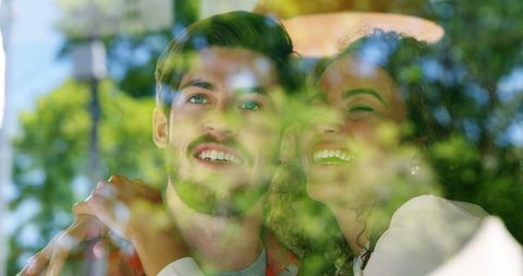 Happy couple enjoying time together viewed through window