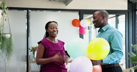 Colleagues Decorating Office For Celebration Event