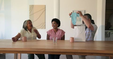 Multigenerational Family Gift Exchange Smiling Together at Home