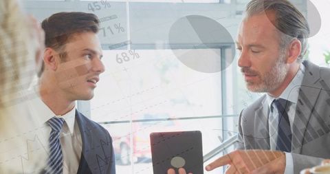 Executives reviewing tablet with finance charts and percentage overlays in modern office