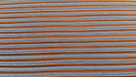 Aerial View of Neatly Plowed Field with Furrow Patterns