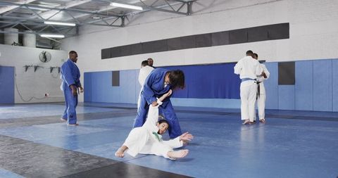 Martial arts students practicing grappling and arm control