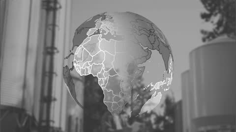 Rotating Digital Globe Over Modern Factory Scene