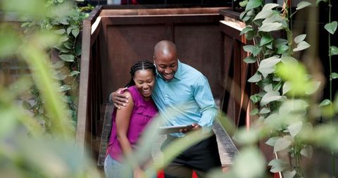 Coworkers Reviewing Project on Tablet Outdoors