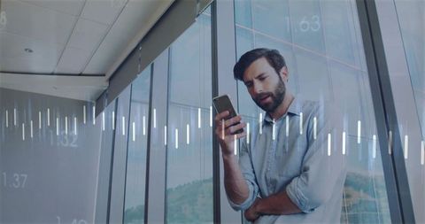 Professional Man Analyzing Data on Smartphone in Modern Office