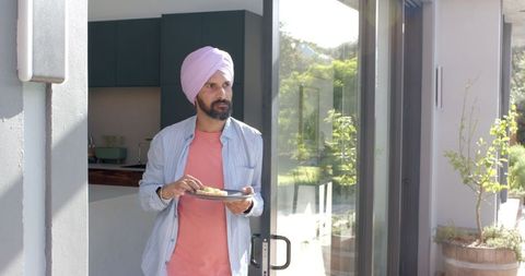 Man in turban dining outdoors in contemporary home setting