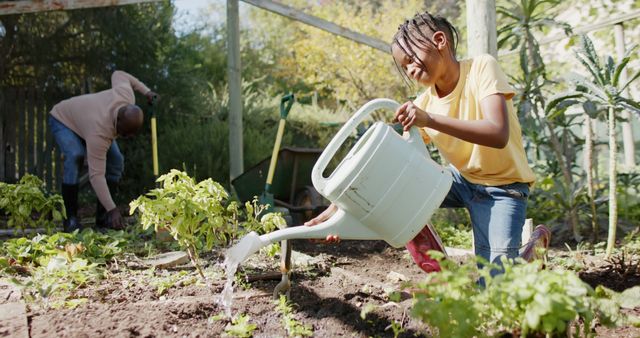 Young girl watering plants while her grandfather is gardening in the background; ideal for themes like family activities, outdoor fun, gardening tips, family bonding, sustainability, and healthy lifestyle.