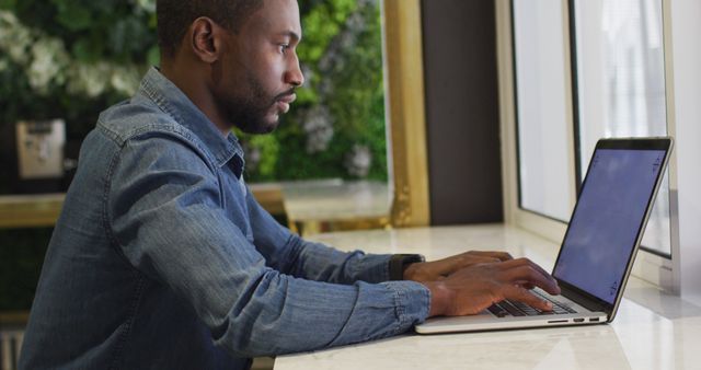 Focused Man Working on Laptop in Cozy Indoor Environment - Download Free Stock Images Pikwizard.com