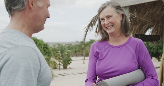 Smiling Retired Couple with Yoga Mats Enjoying an Outdoor Chat - Download Free Stock Images Pikwizard.com