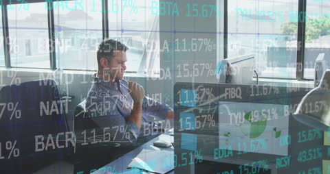 Financial Data Overlaid on Businessman at Workplace