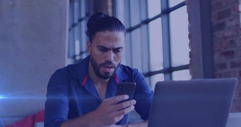 Businessman Staring Surprised at Smartphone Screen in Office