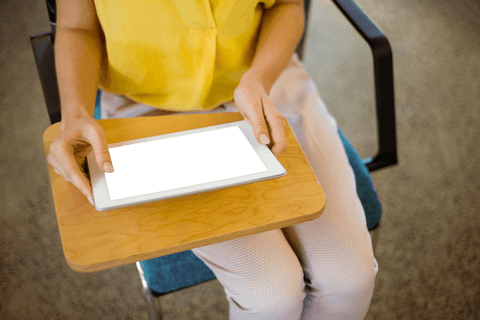 Female business executive working in office, holding digital tablet with transparent screen, midsection focused. Ideal for illustrating technology use in professional settings, digital advertisements, or workspace design content. Perfect for layouts needing space for app interfaces.